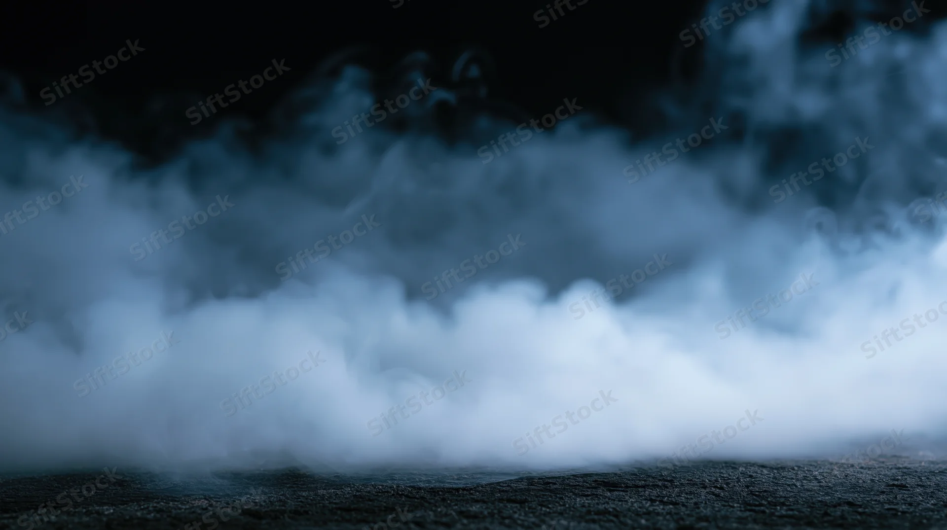 Swirling white smoke rising from a dark textured surface at night