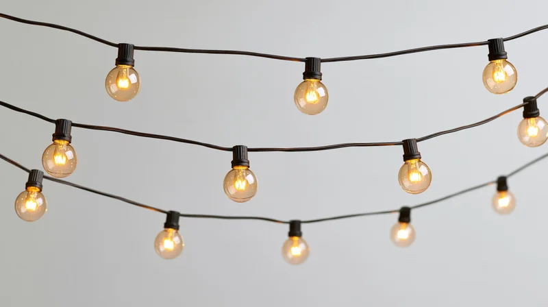 String of warm glowing bulbs arranged in rows against a plain background