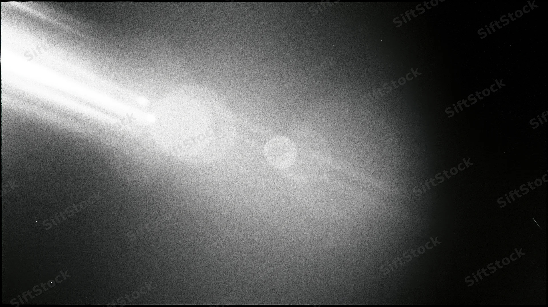 Bright celestial bodies glowing in deep space with lens flare and cosmic light trails