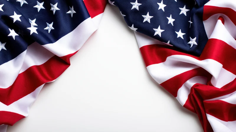 American flag draped in corners on white background with copyspace