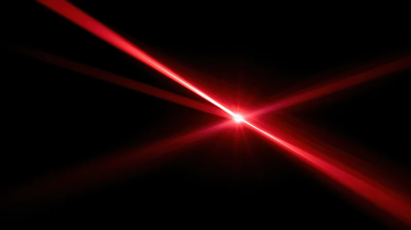 Red laser beams converging at center against black background