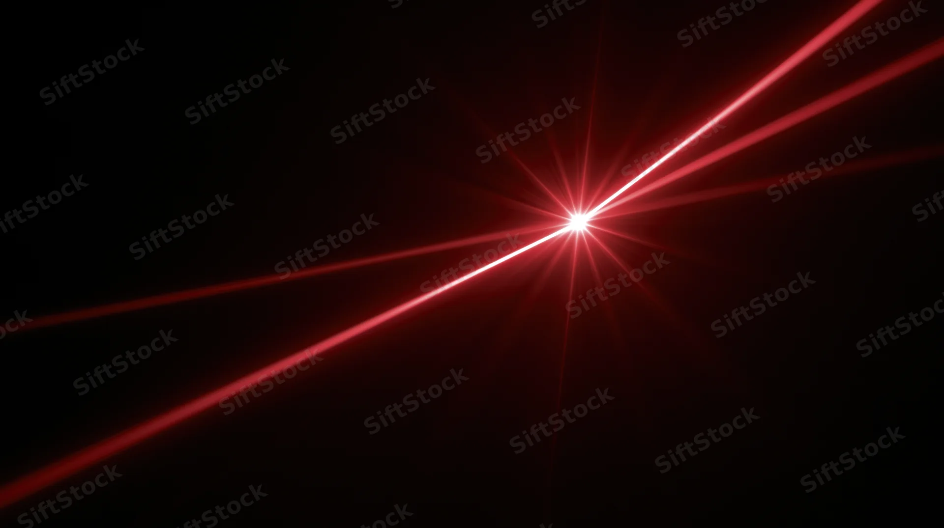Red laser beams radiating from a central bright point in darkness