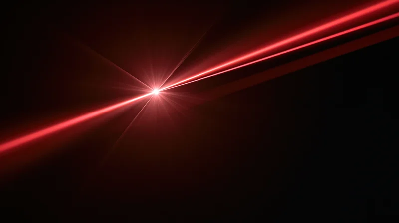 Red laser beams converging to a bright focal point in dark space