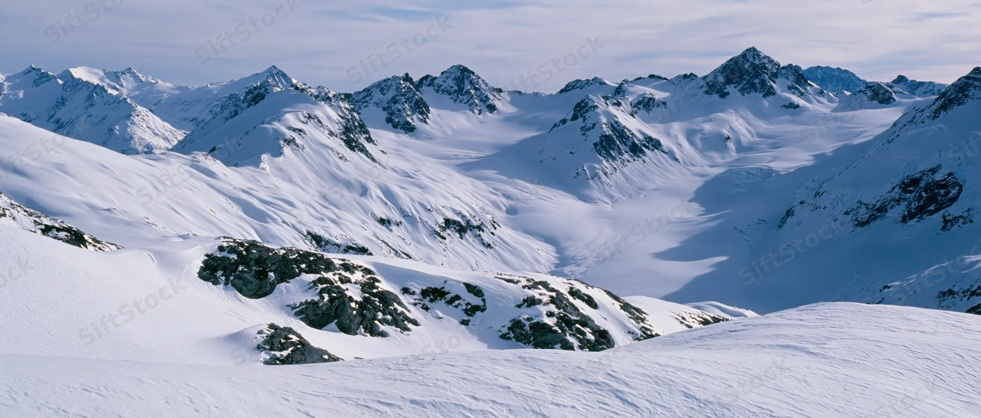 Snow-covered mountain peaks and glaciers in alpine terrain