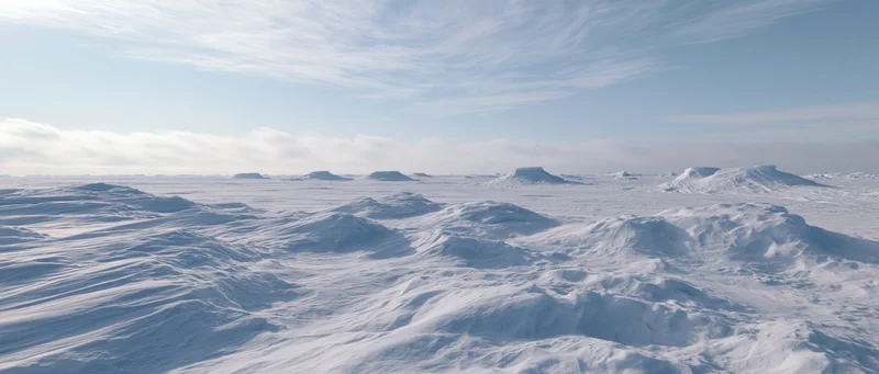 Snow-covered arctic tundra landscape with ice ridges and distant plateaus under a pale blue sky