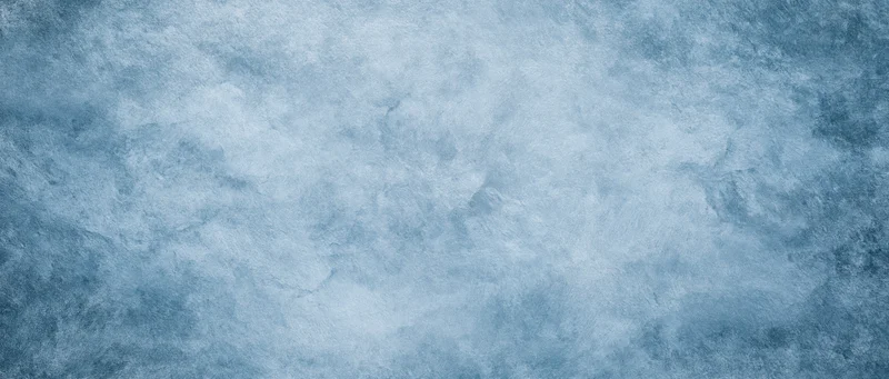 Abstract blue textured surface with mottled frost-like pattern filling the frame