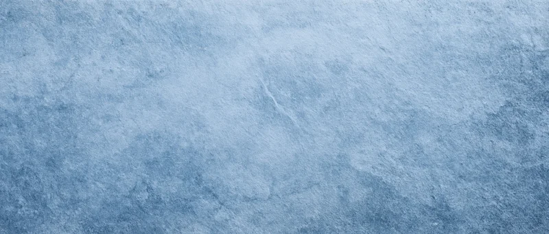 Textured blue stone surface with subtle variations in tone and roughness