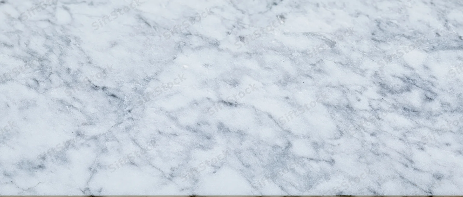 Close-up of white marble surface with gray veining, used as a seamless background for interior design applications
