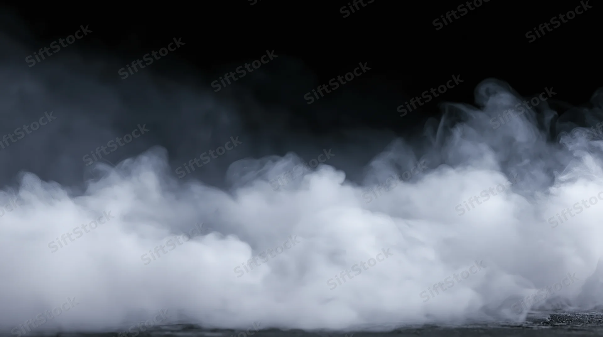 Swirling white smoke rising from a dark surface against a black background