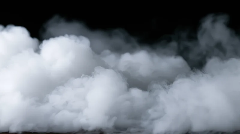 White smoke billowing across a black background in a studio setting