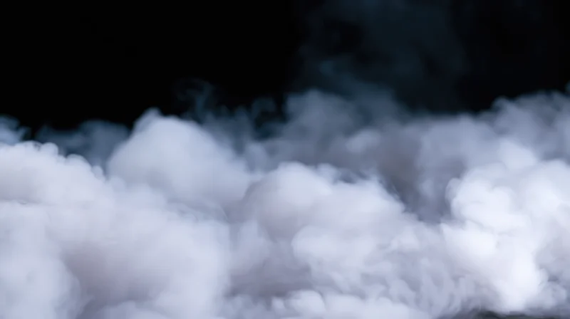 White smoke billowing against a dark background with soft texture and depth