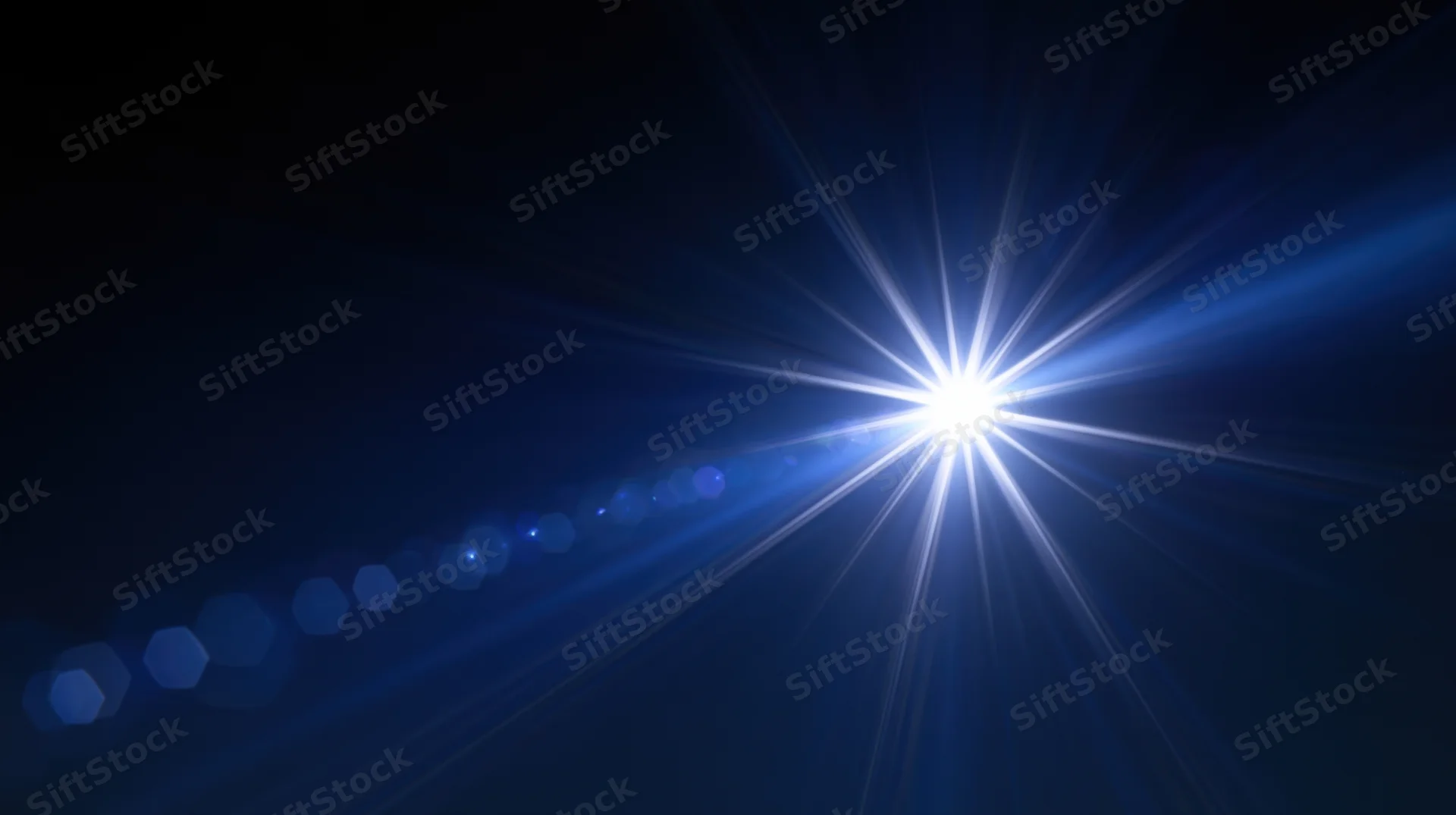 Bright starburst light flare with blue gradient and hexagonal bokeh in dark abstract background