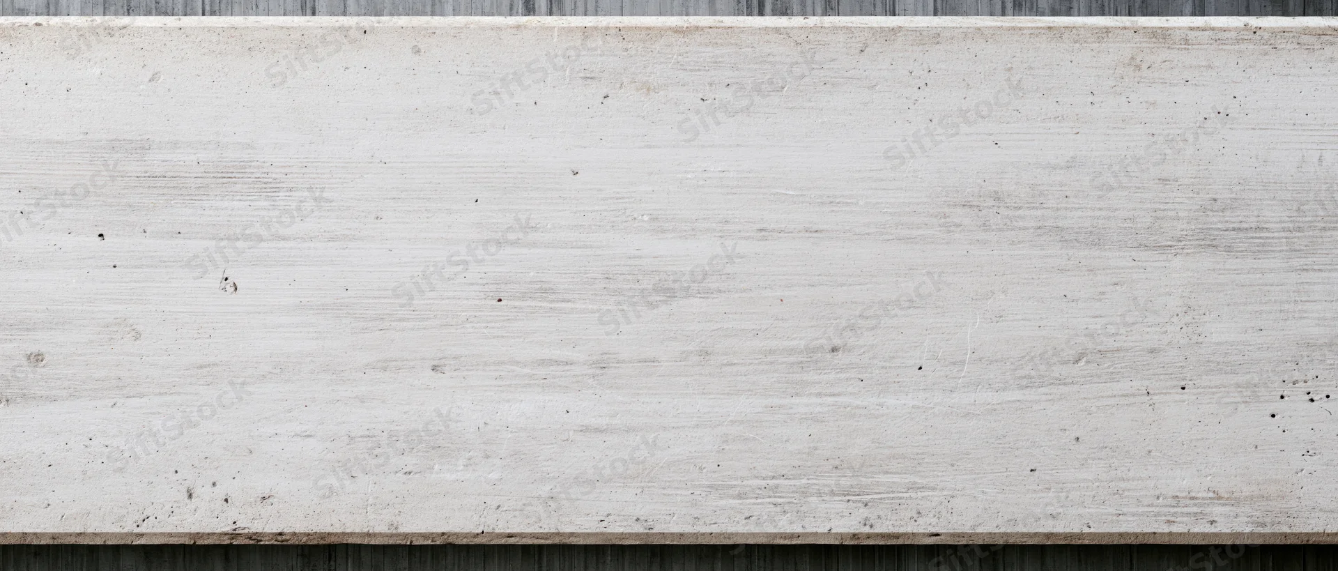 Horizontal concrete slab with textured surface and visible grain, framed by dark edges above and below