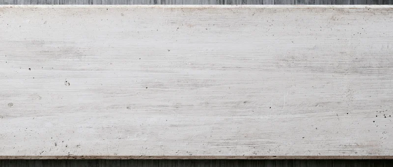 Horizontal concrete slab with textured surface and visible grain, framed by dark edges above and below
