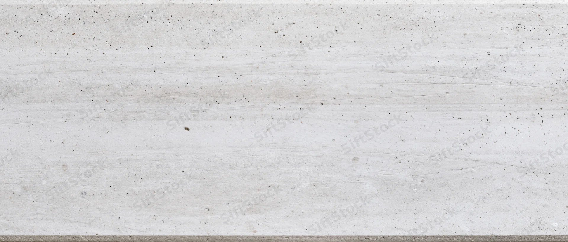 Closeup of a white veined marble surface with natural speckles and grain, used as a background for interior design