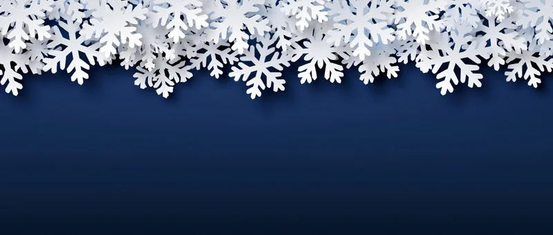 White paper snowflakes arranged as a decorative border along the top of a dark blue background with copyspace below