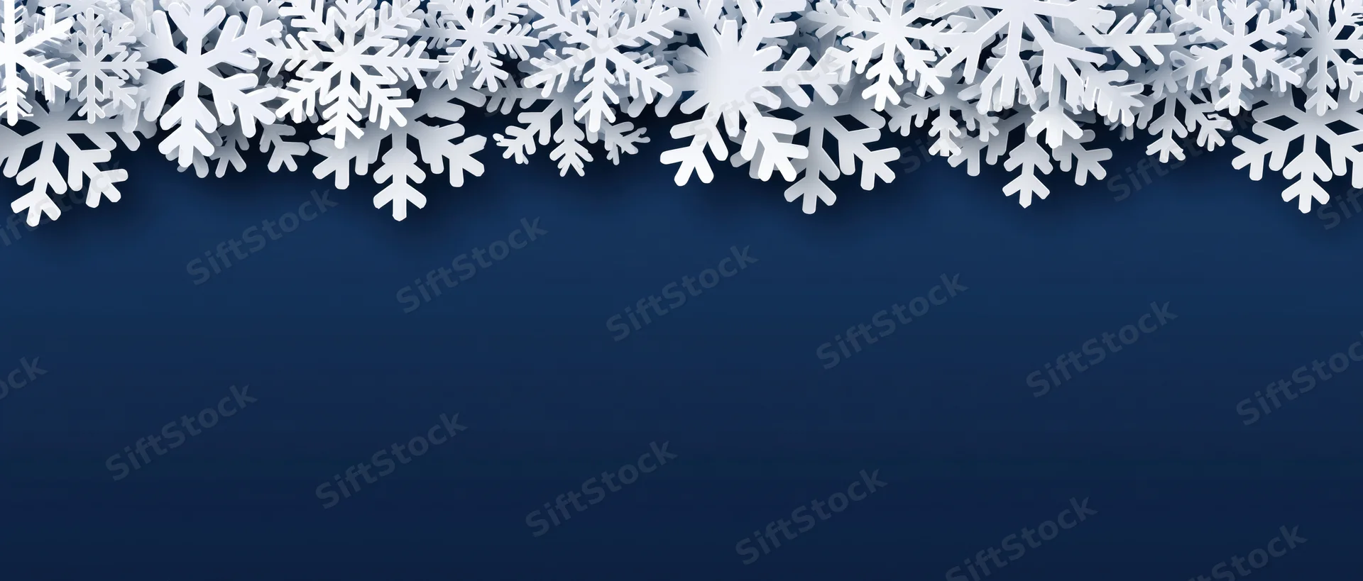 White snowflake border arranged along the top edge of a dark blue background with copyspace below