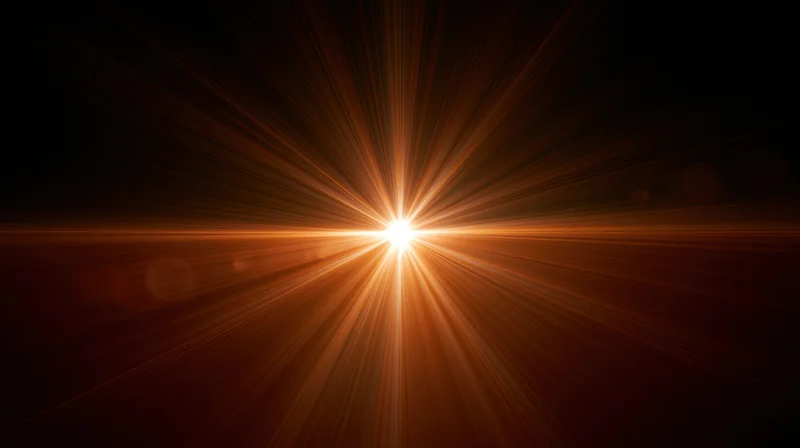 Radiant light burst with golden rays spreading from center against dark background