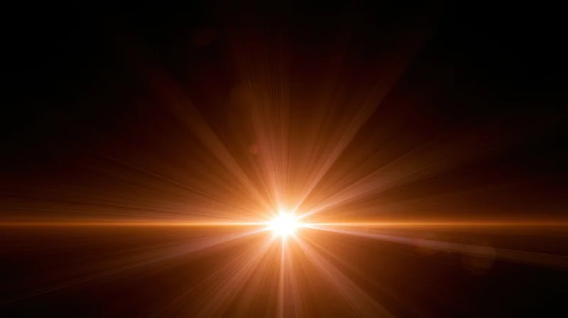 Bright orange light burst radiating from center against dark background with horizontal flare and copyspace
