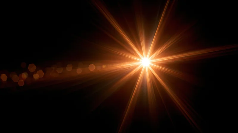 Bright starburst light flare radiating from center against dark background with bokeh highlights
