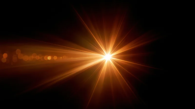 Bright starburst light flare radiating from center against dark background with bokeh circles to the side