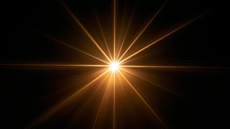 Bright golden starburst light radiating from center against black background