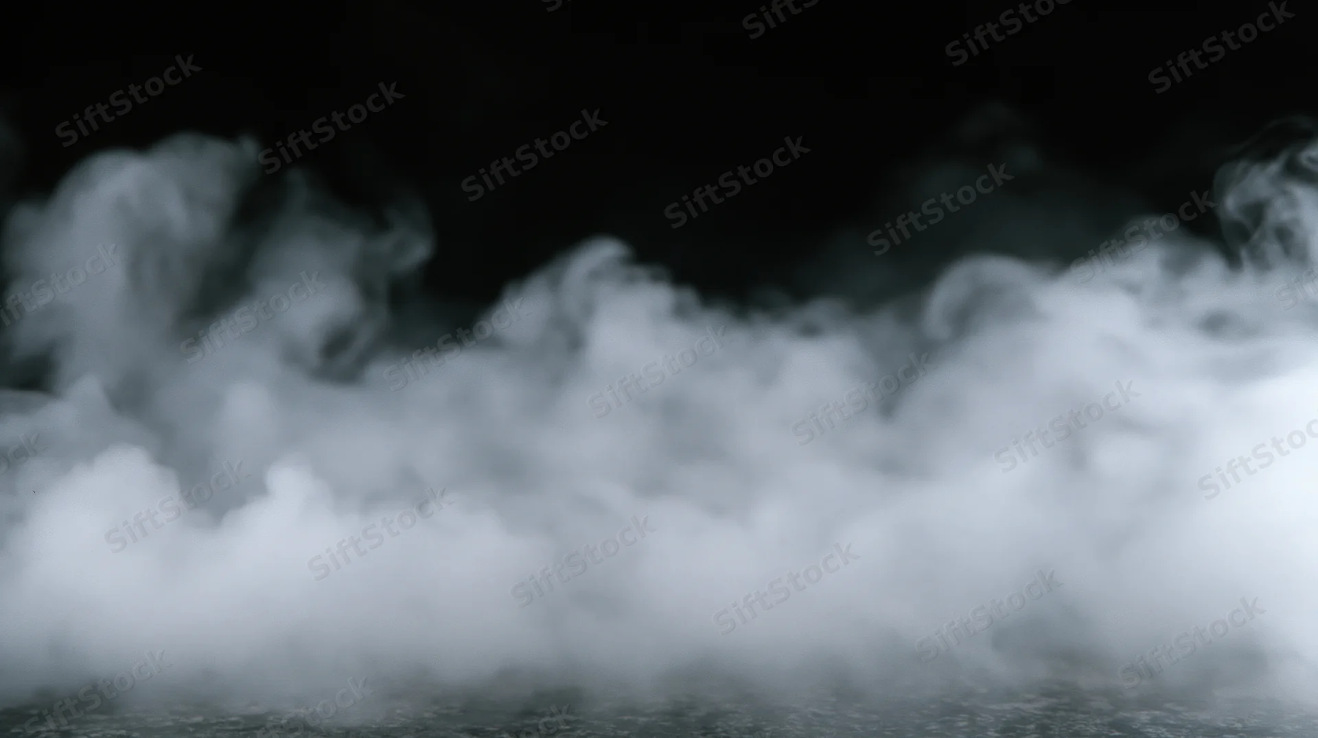 Swirling white smoke rising from a dark surface, filling the frame with dense vapor and soft shadows