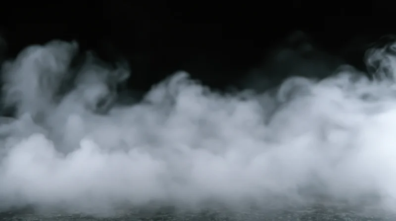 Swirling white smoke rising from a dark surface, filling the frame with dense vapor and soft shadows