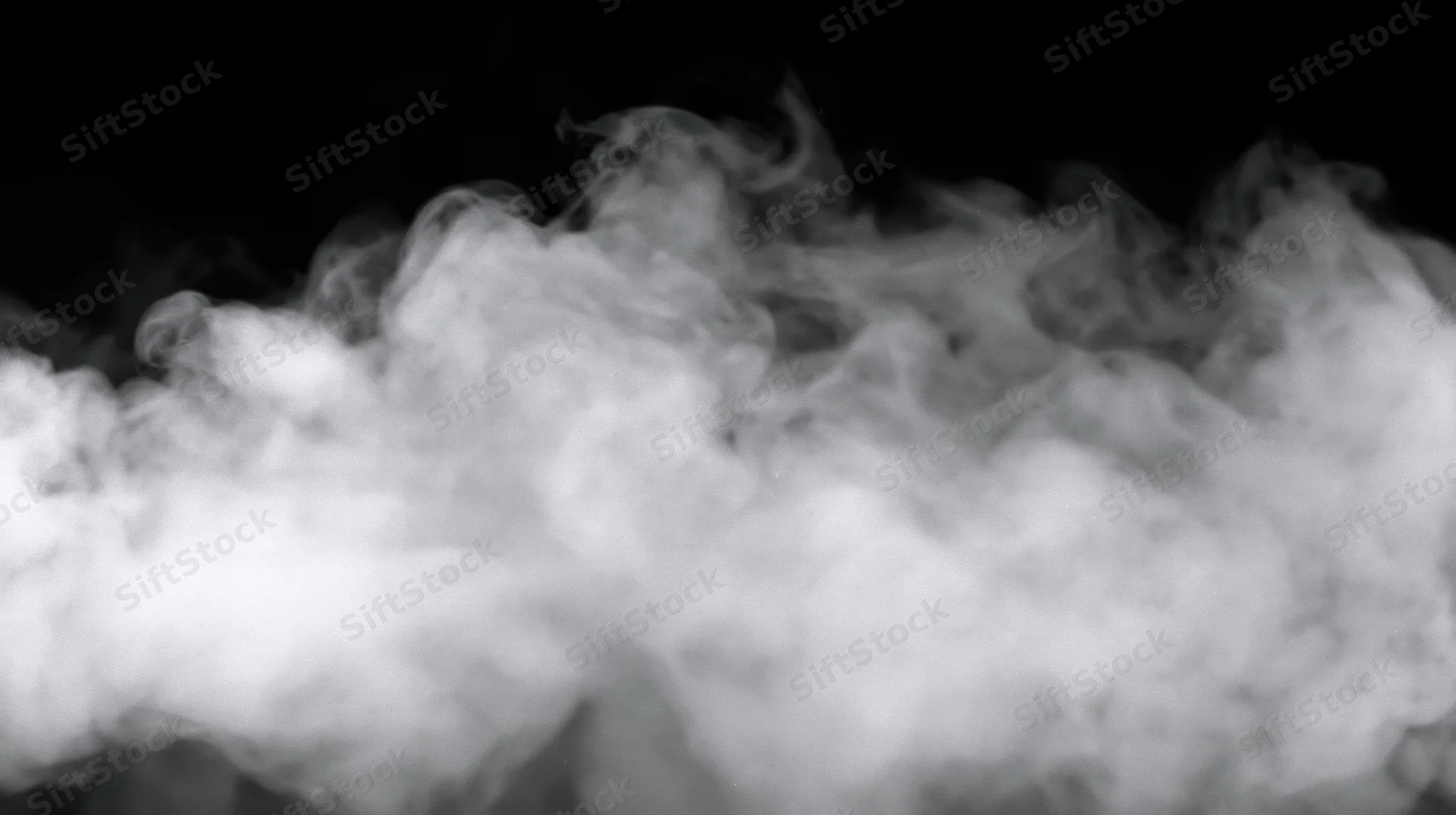 White smoke billowing against black background with soft swirling motion and copyspace
