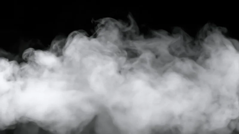 White smoke billowing against black background with soft swirling motion and copyspace
