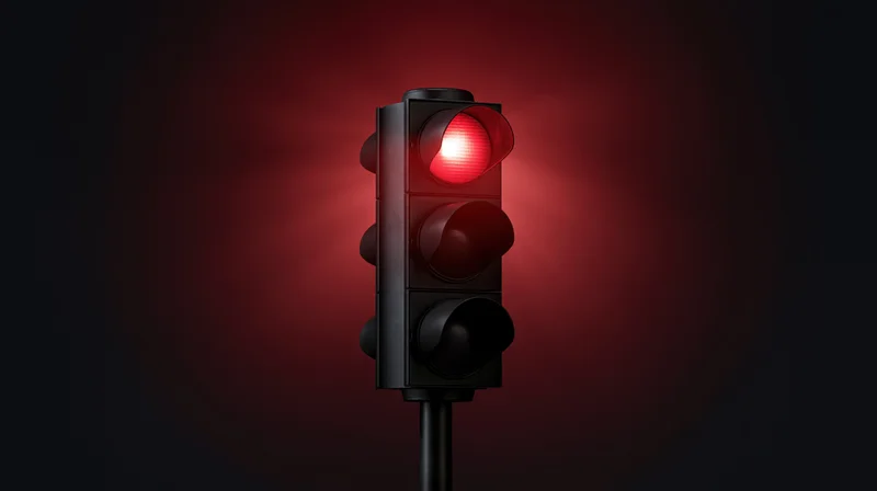 Traffic light with red signal illuminated on dark background