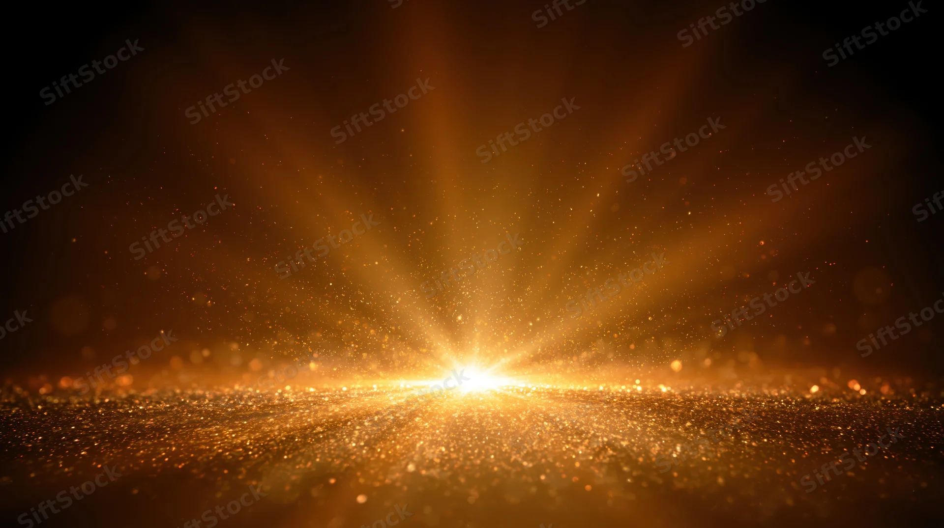 Golden light bursting from horizon over sparkling surface with radiating rays and floating particles