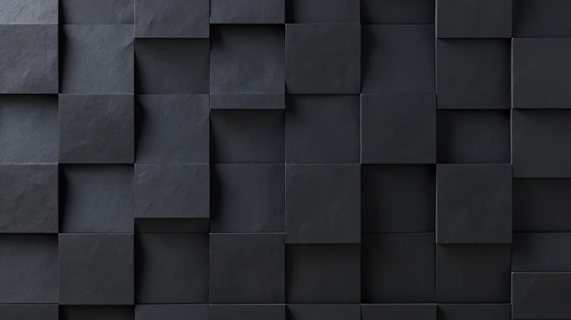 Black geometric cubes arranged in a 3d relief pattern on a wall surface