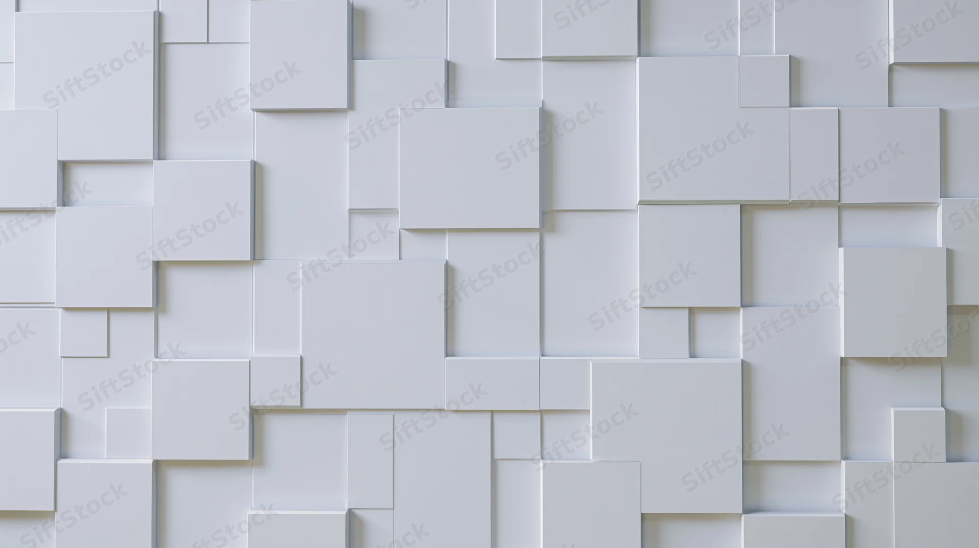 White geometric cubes arranged in a modular 3d pattern on a wall surface