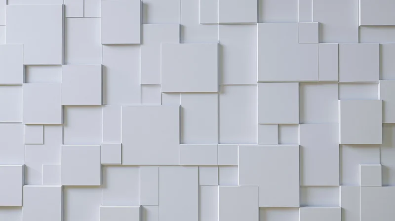 White geometric cubes arranged in a modular 3d pattern on a wall surface