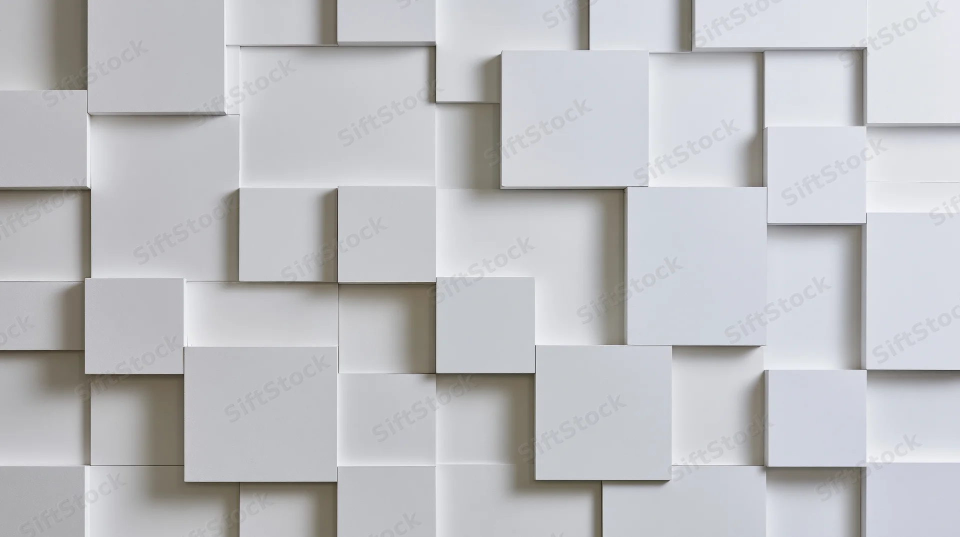 White geometric cubes arranged in a 3d pattern on a wall surface