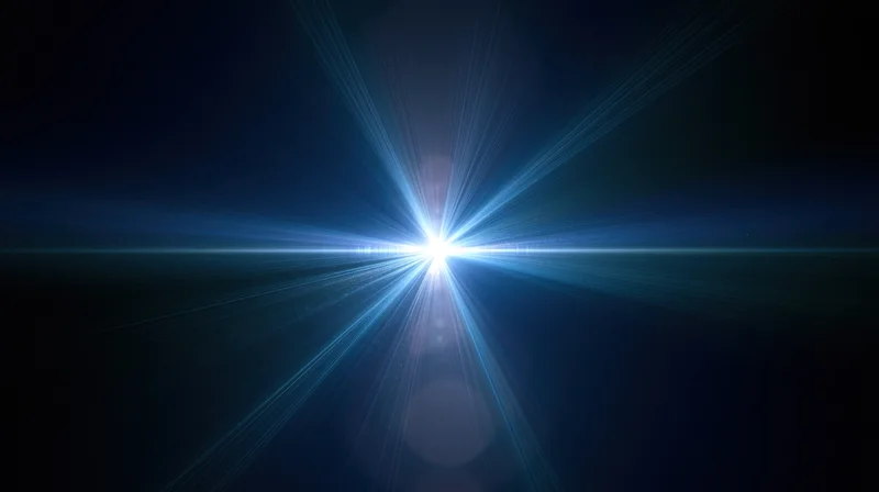 Bright blue light burst radiating from center against dark background with lens flare and copyspace