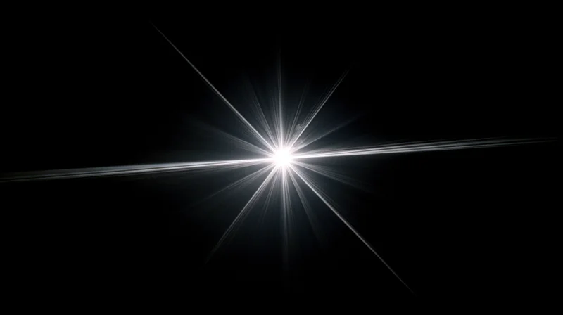 Bright starburst light flare radiating from center against black background