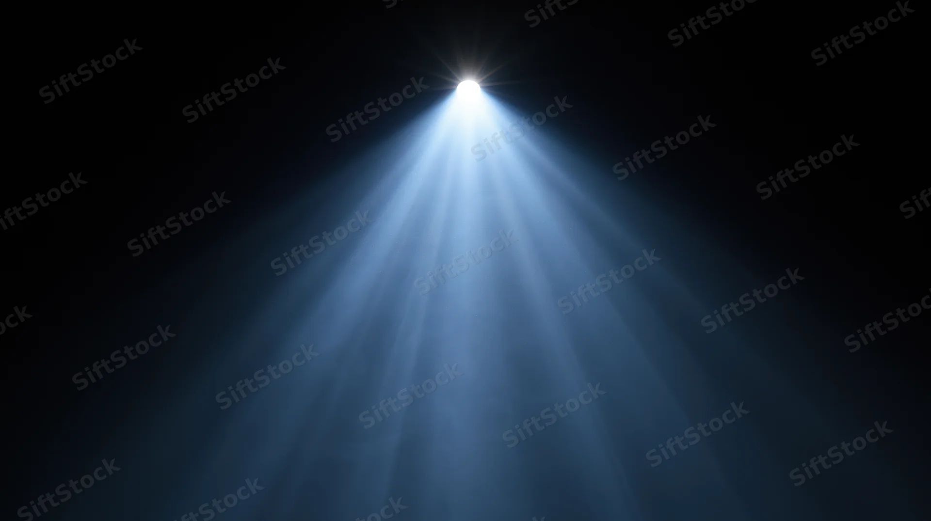 Spotlight beam shining down from above in a dark space