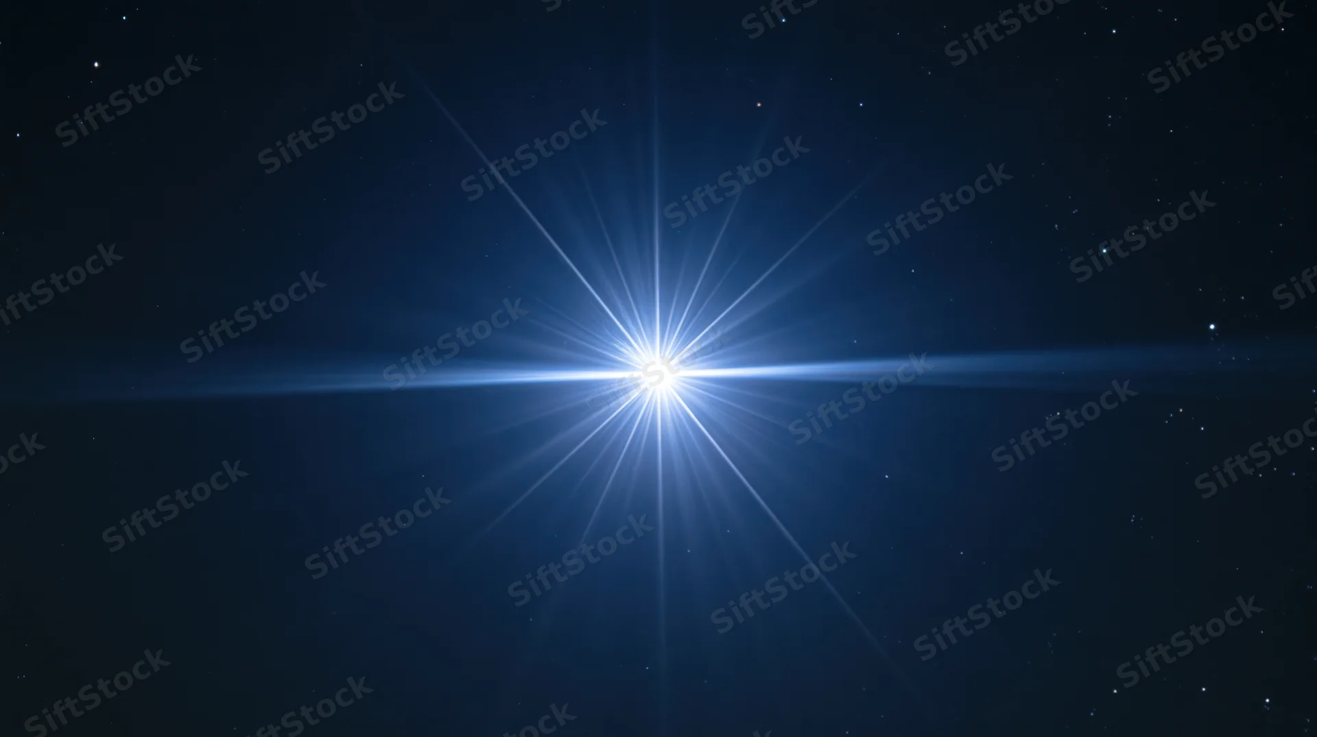Bright star radiating light beams across dark night sky