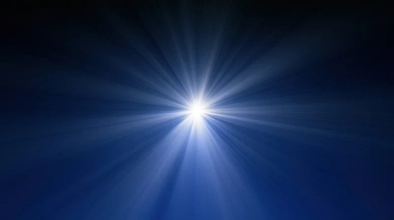 Bright white light burst radiating from center against dark blue background