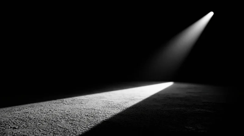 A spotlight beam illuminating a textured carpet in a dark room