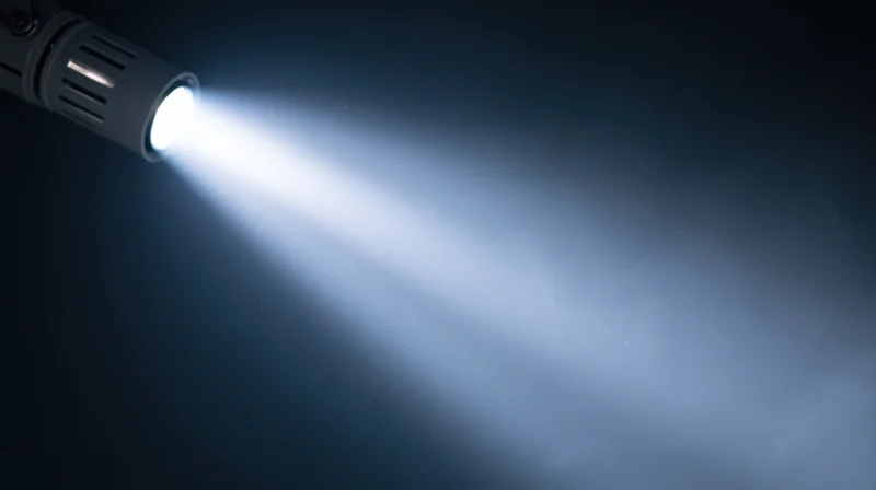 Flashlight emitting bright beam of light in dark environment