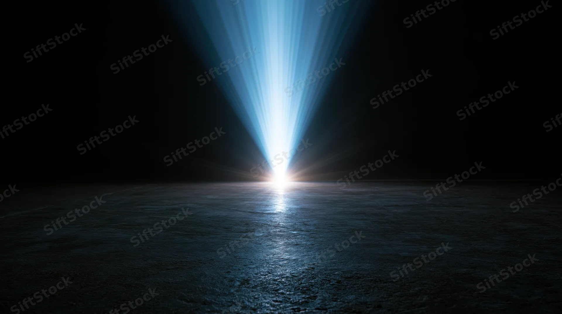 Bright blue light beam shining down on dark water surface at night