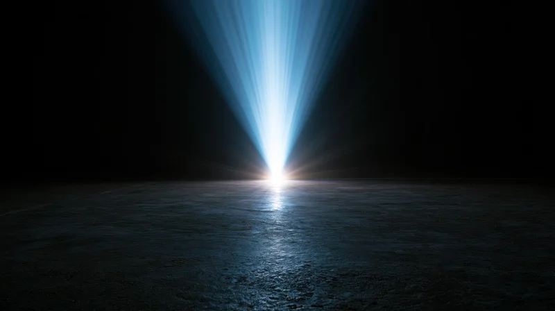 Bright blue light beam shining down on dark water surface at night