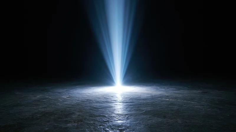 A bright blue light beam shining down onto a dark textured floor, creating a glowing spotlight in the center
