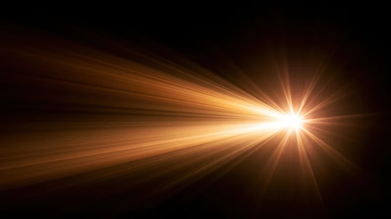 Bright golden light burst radiating from center against dark background with copyspace