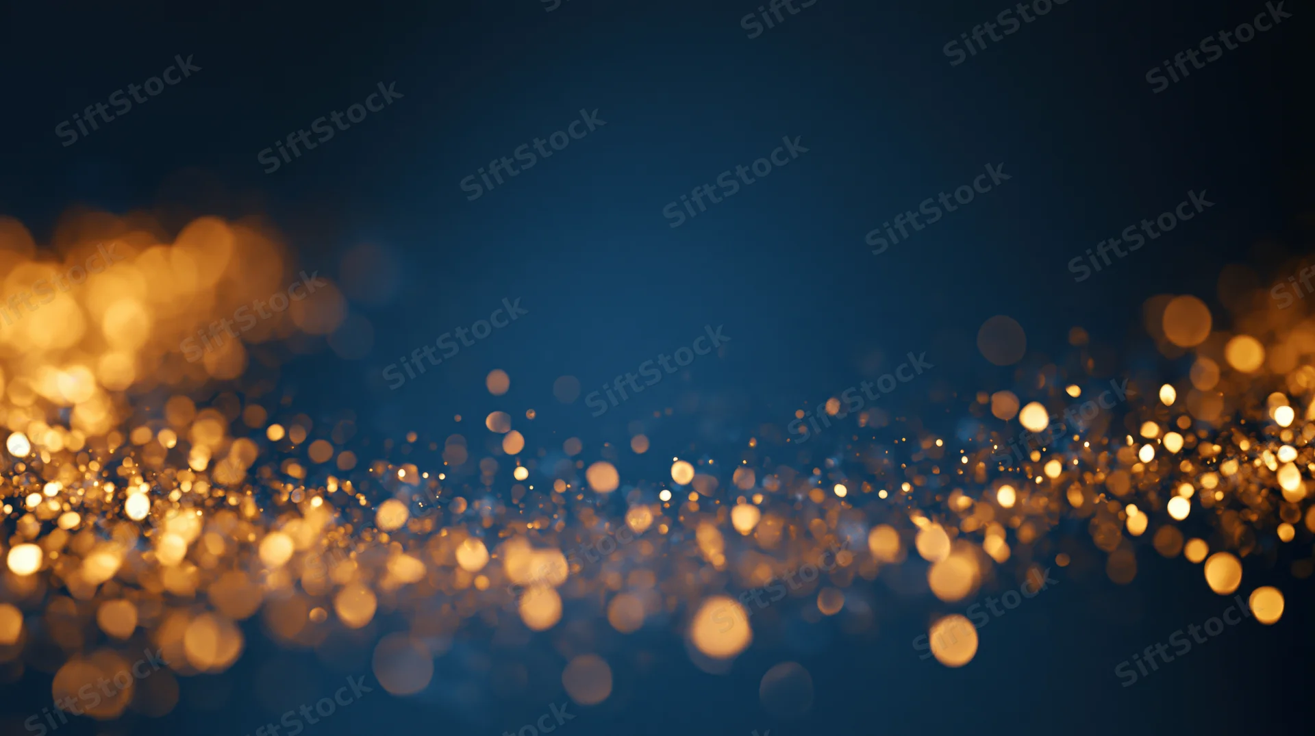 Golden bokeh lights scattered across a dark blue background with soft glow and sparkle