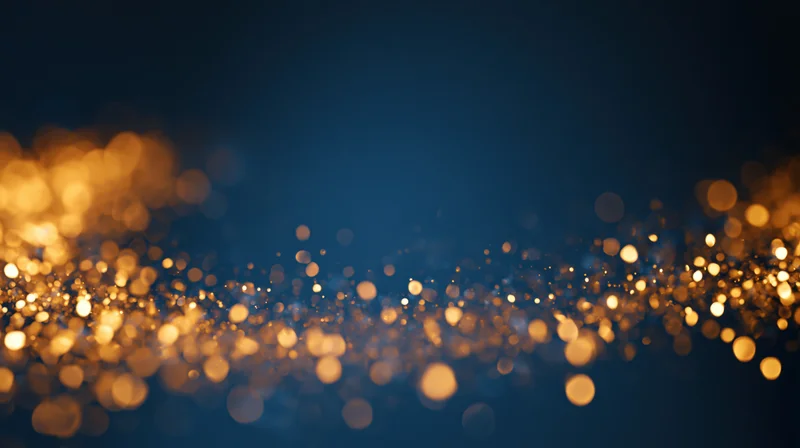 Golden bokeh lights scattered across a dark blue background with soft glow and sparkle
