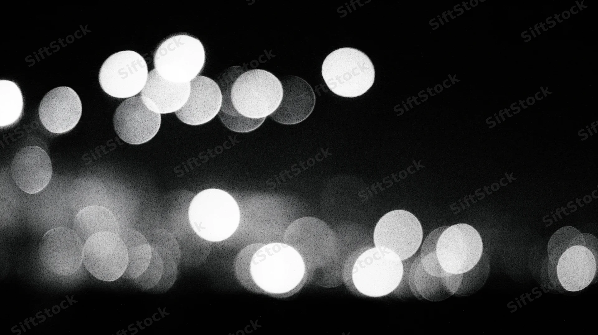 Blurred circular lights arranged in rows against a dark background
